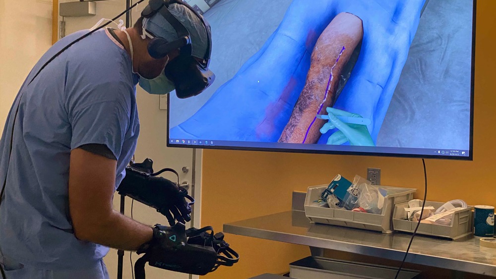 Surgeon performs a simulated escharotomy using haptics.
